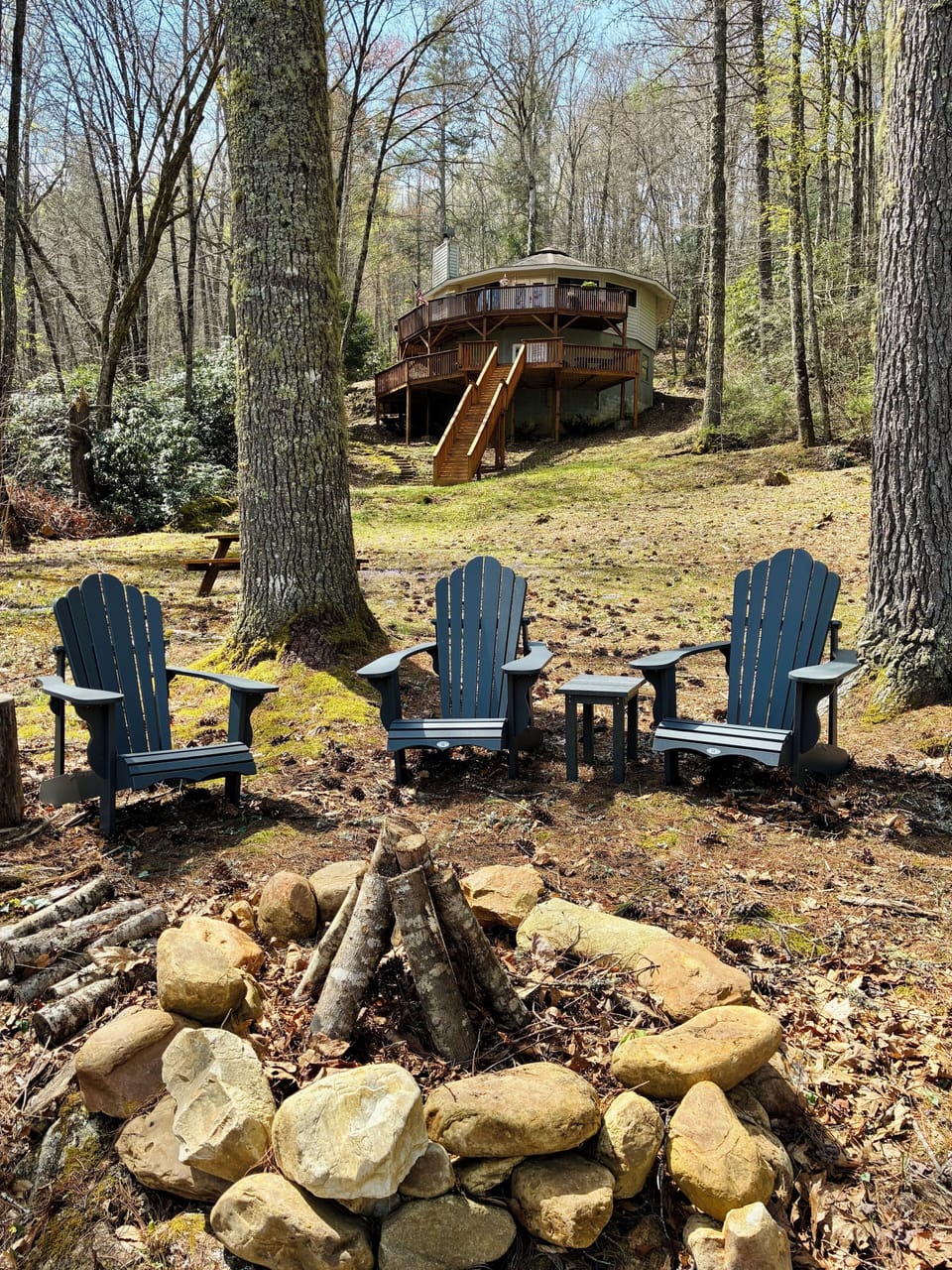 Lakeside fire pit with the home in the background. 