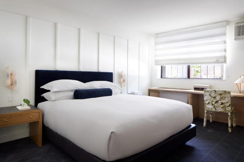 Unwind in crisp linens and a serene, modern retreat.