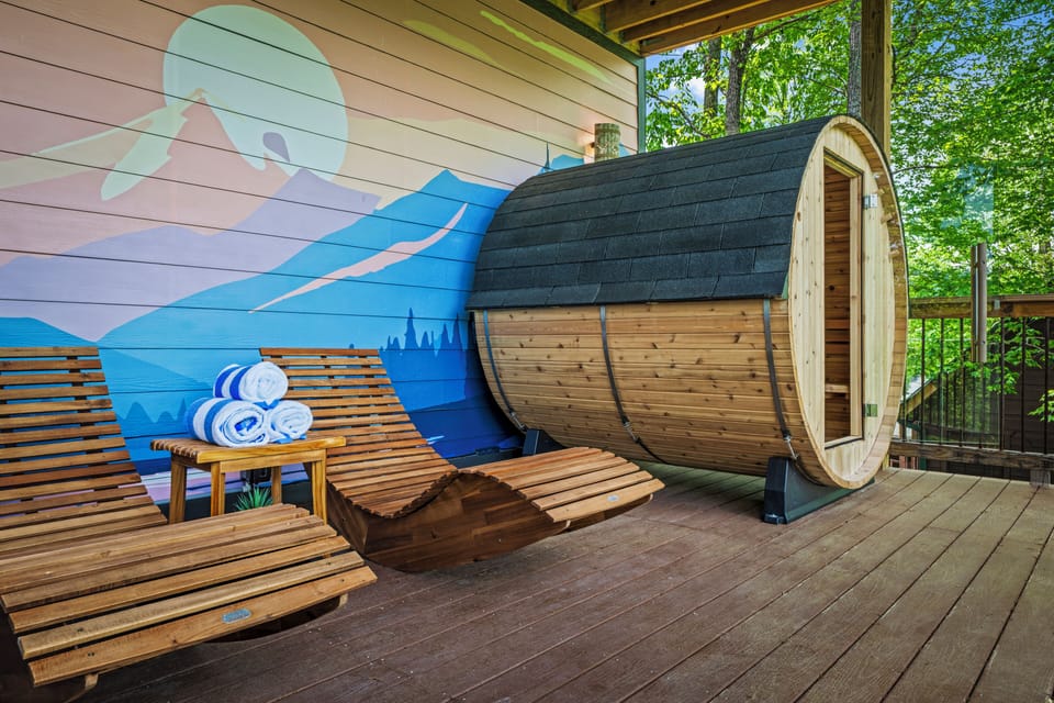 Unwind with spa chairs, barrel sauna, and stunning views in peaceful nature.