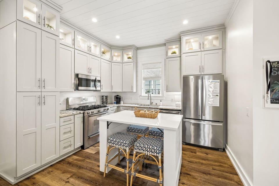 This light-filled coastal kitchen offers everything you need, from premium appliances and abundant storage to a spacious island that's perfect for breakfast, happy hour, or planning your next beach day.