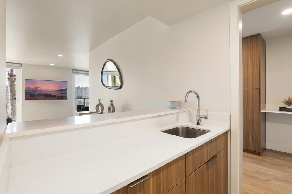 Extra prep area with a second sink and view of the living space