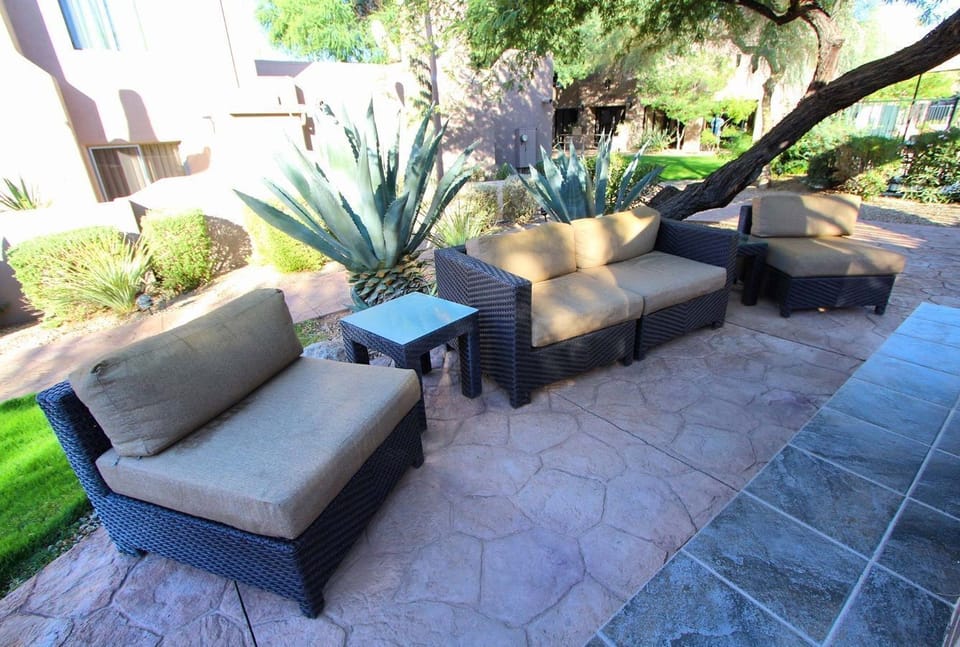 A tranquil private patio area with comfortable seating, surrounded by the scenic desert landscape, ideal for outdoor relaxation.