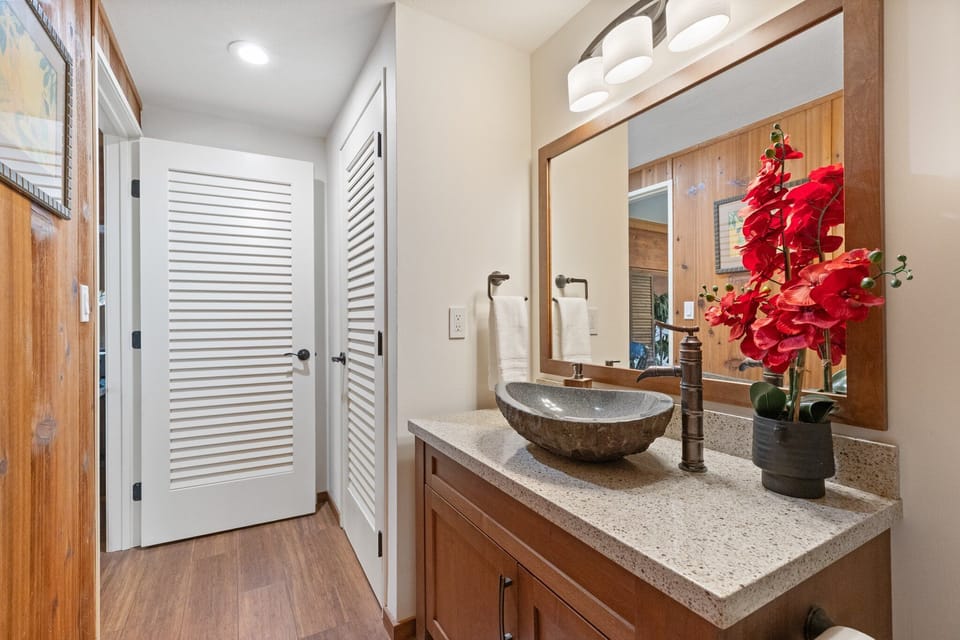 First bathroom features a modern walk-in shower.