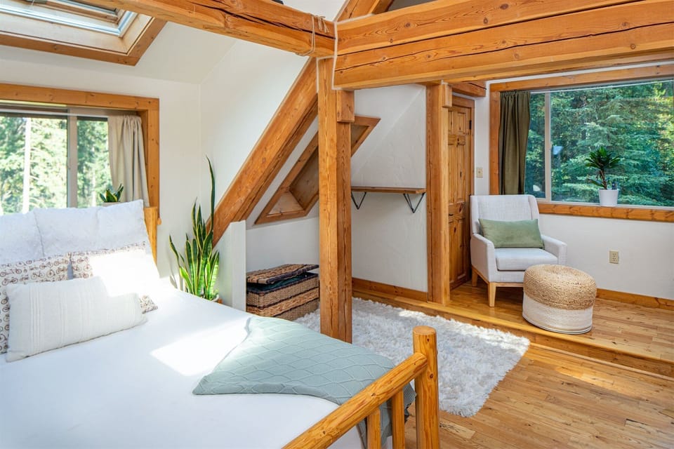 The master suite offers a queen bed, seating area, private balcony & private full bathroom | Upper Level