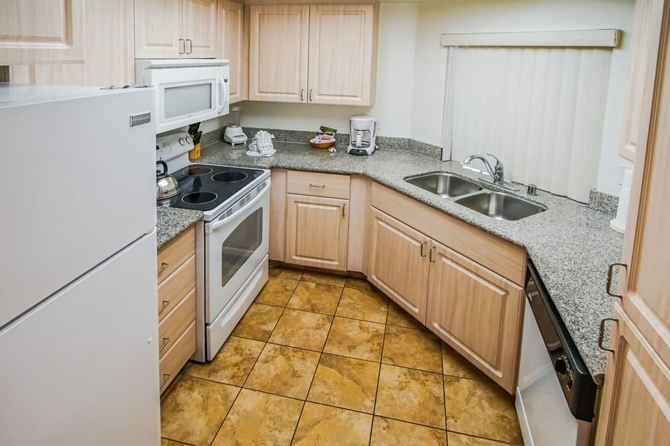 The full kitchen, complete with modern appliances and ample counter space, invites culinary adventures and family meals in a cozy setting.