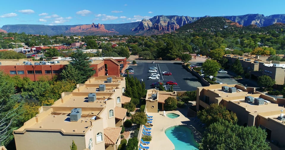 Relax by the outdoor pool surrounded by lush greenery, with breathtaking mountain views adding to the tranquil atmosphere for a perfect retreat.