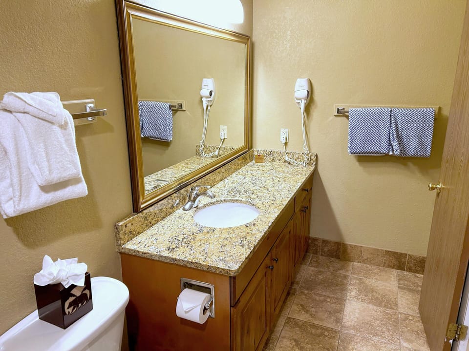 Featuring a stylish vanity with granite countertops and generous storage space, this bathroom is thoughtfully designed for convenience and luxury.