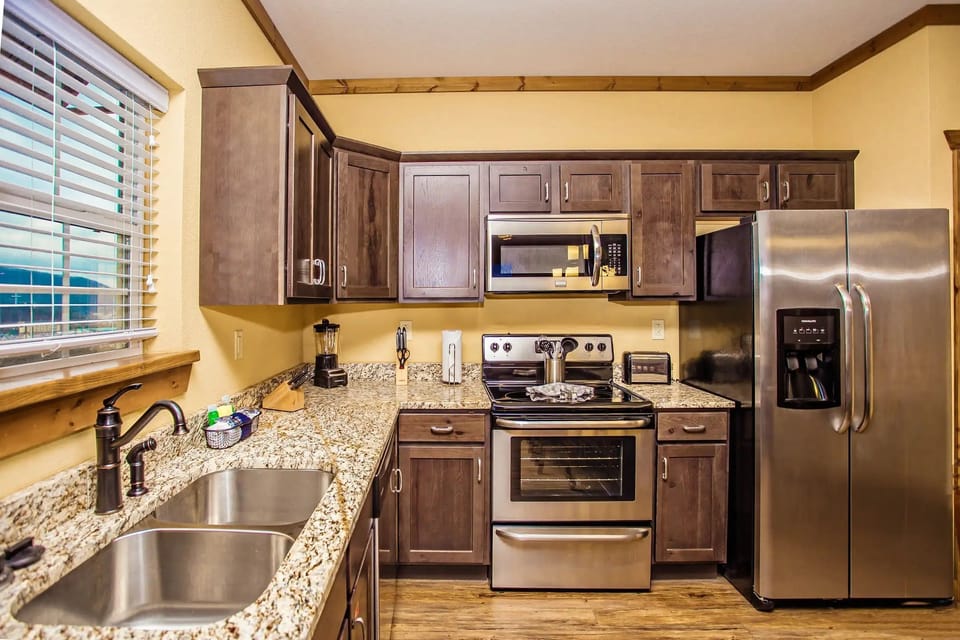 Experience culinary delights in the modern kitchen featuring stylish wood cabinetry, sleek countertops, and all the essential appliances for your Sedona retreat.