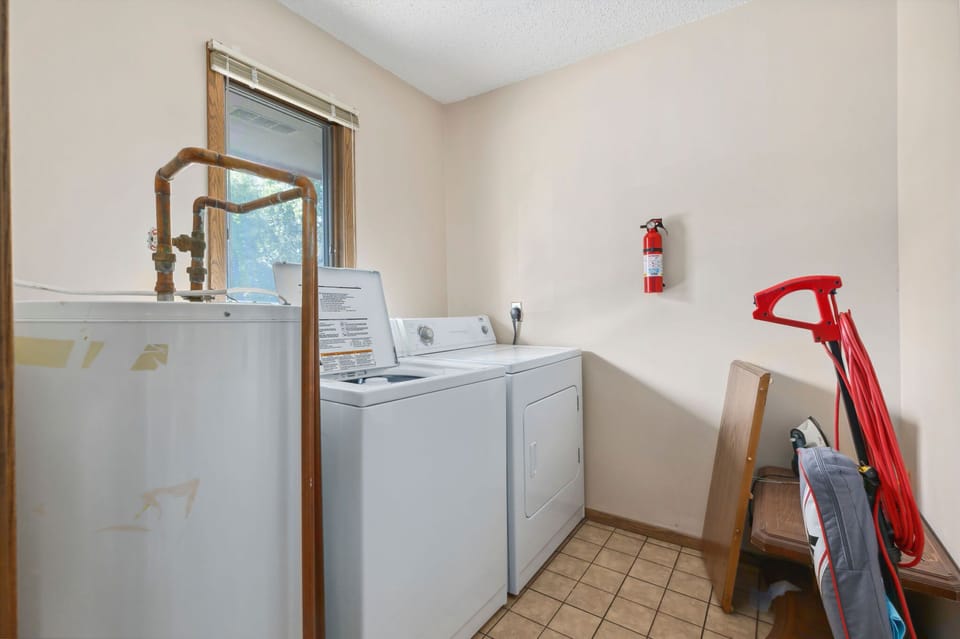 In-unit laundry with washer, dryer, and storage space.
