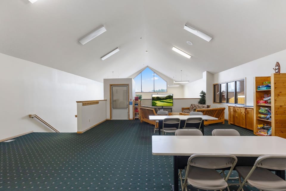 This spacious common room is perfect for gatherings, equipped with seating and entertainment options to foster community interactions.