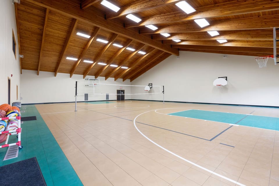 Full-size indoor basketball court for games and recreation.