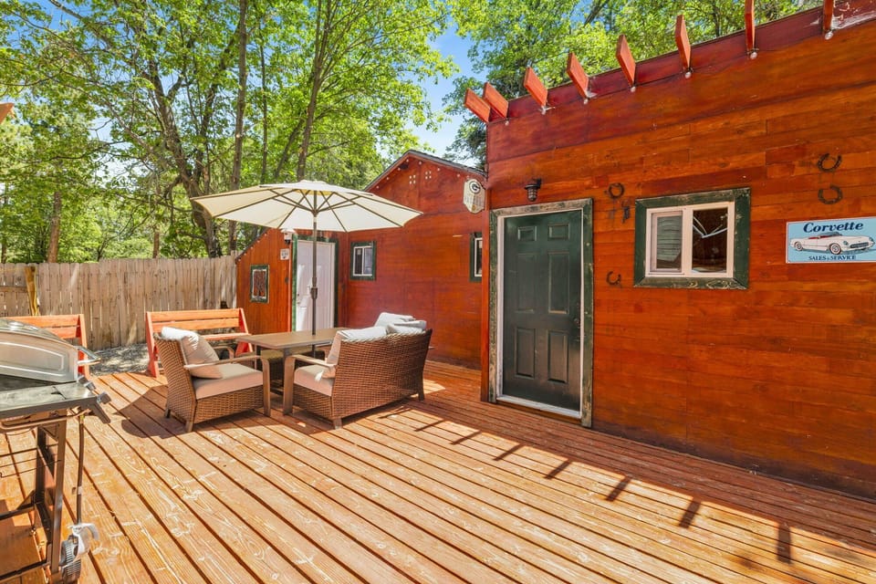 Private outdoor deck, surrounded by tall pines, perfect for relaxing under the trees after a day of adventure enjoy peaceful forest views, fresh air, and a truly rejuvenating stay.