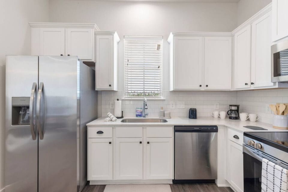 Start your day with coffee or unwind with a snack in this clean, open kitchen setup.