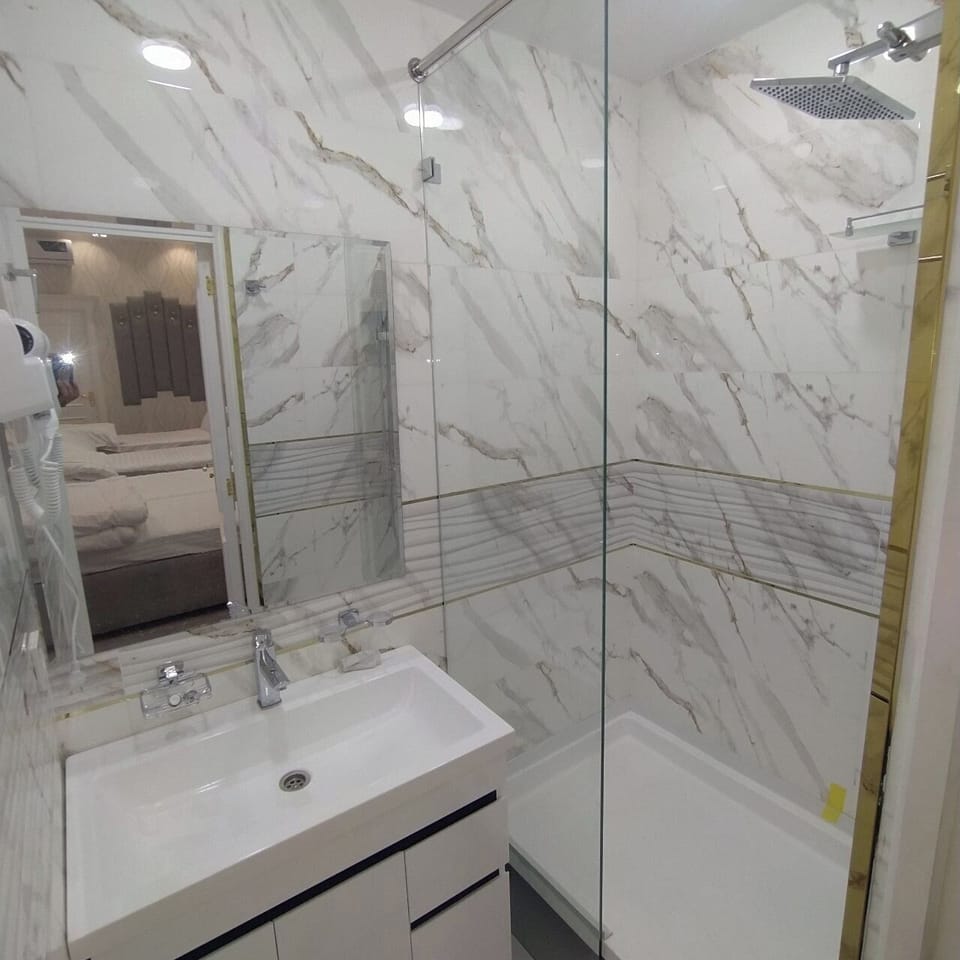 Quadruple Room, City View | Bathroom | Hair dryer, bathrobes, slippers, towels