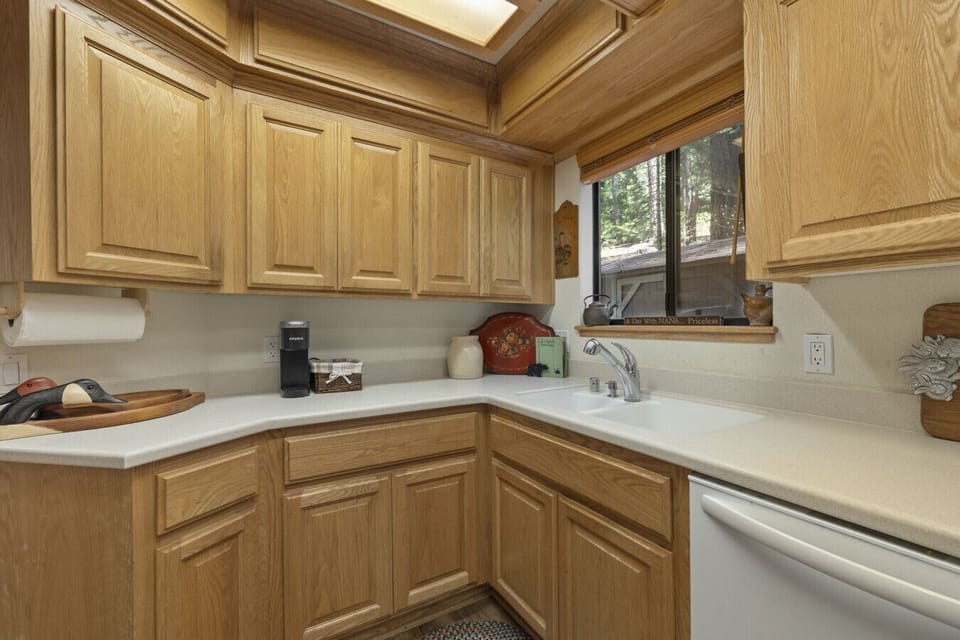 Clean-up is a breeze with a built-in dishwasher and a sunny window above the sink—Nana always knew how to make kitchen time feel easy.