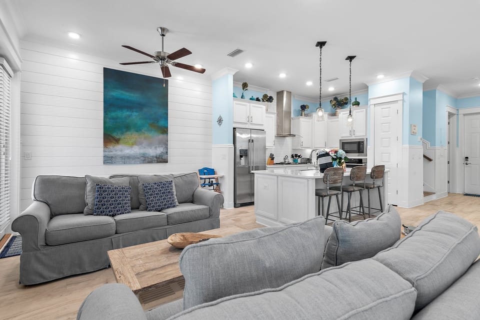 Sink into the plush sectional under bright coastal art after a full day in the sun.