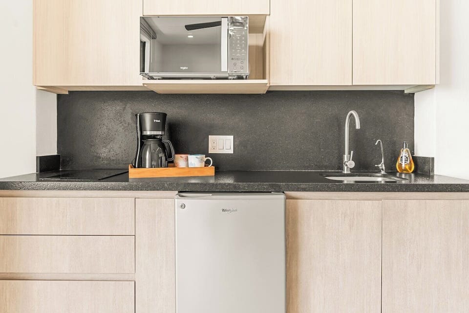Featuring a mini-fridge, microwave, coffee maker, and a two-burner electric cooktop, it’s ready for those moments when you prefer to dine in.