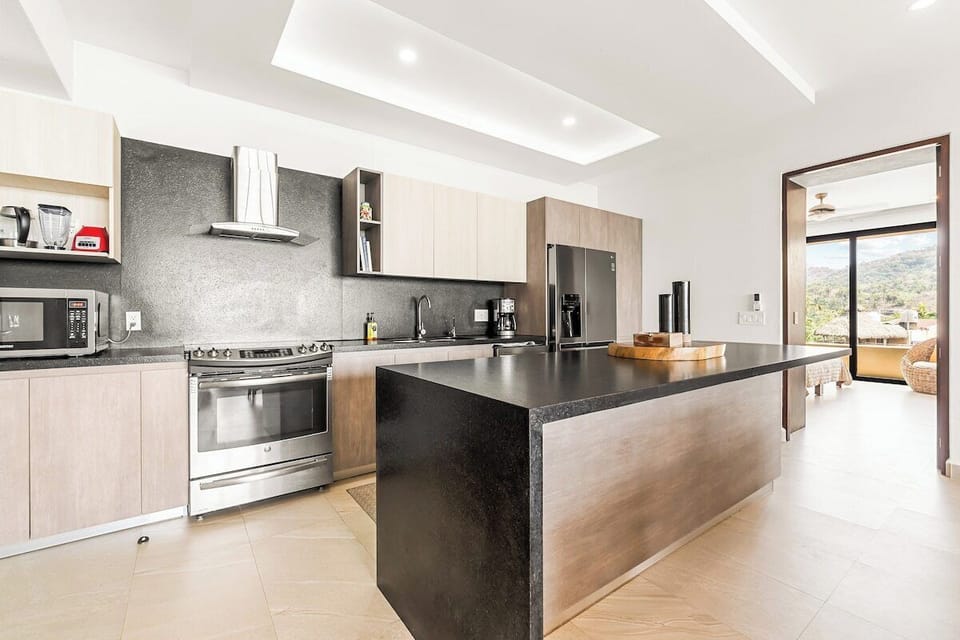 Centered around a spacious island and equipped with modern appliances, the kitchen is ready for everything from a quick snack to a family feast.