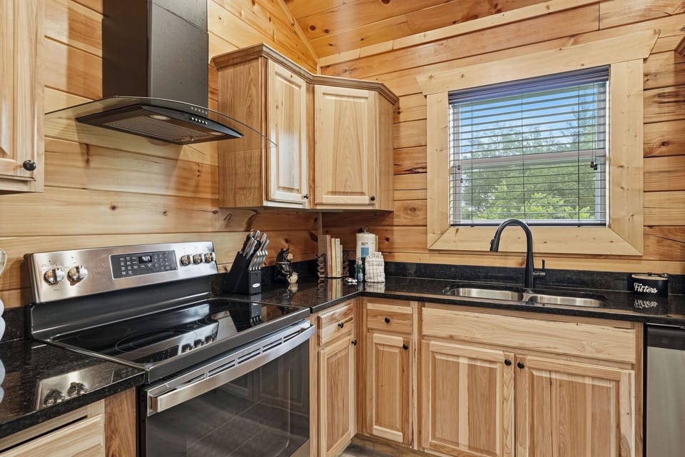 Step into your cozy mountain retreat and discover a fully equipped kitchen where rustic charm meets modern convenience. Warm wood tones and sleek appliances invite you to prepare meals surrounded by natural beauty streaming through the windows.