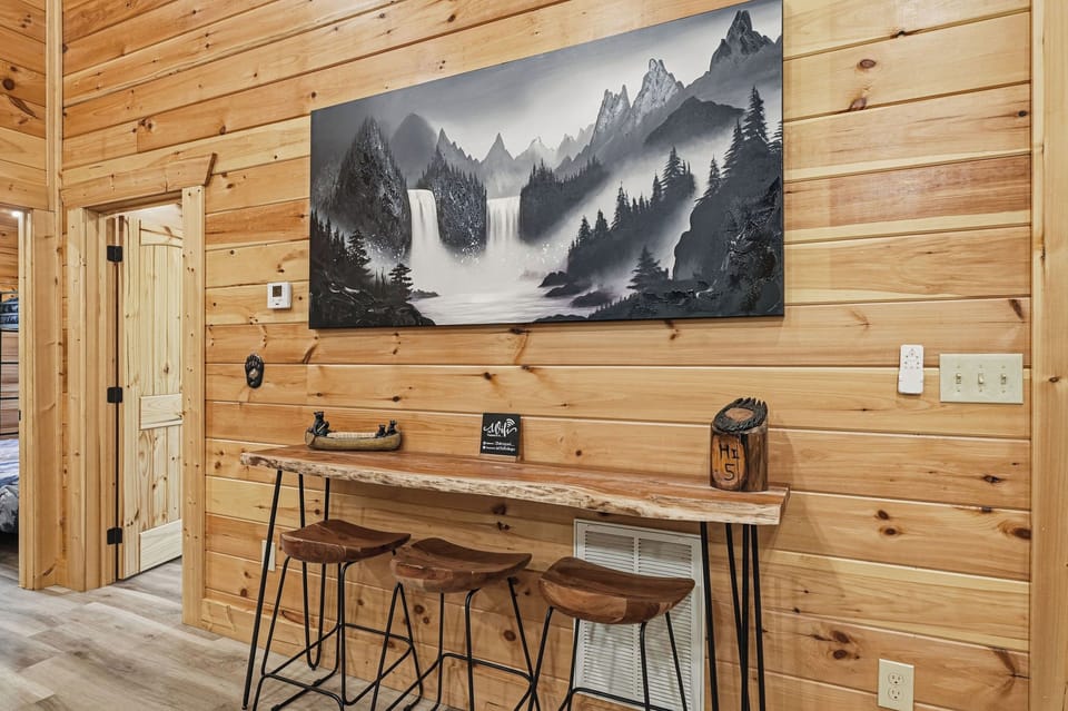 Warm wood tones and mountain artwork create your perfect spot to gather over morning coffee or plan the day's adventures at this cozy bar-height table.