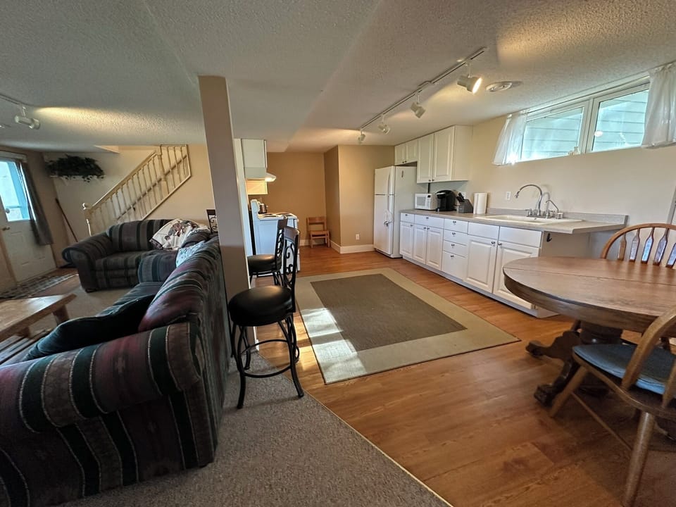 Lower level living room (ground level) and kitchen.