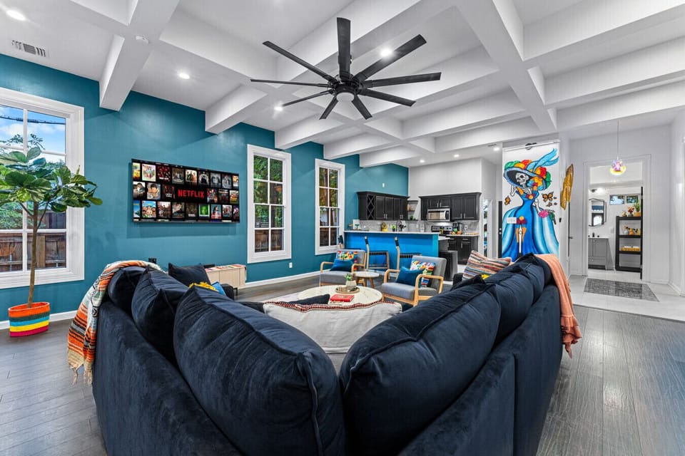 Gather in a vibrant, spacious living area with bold decor and a fully equipped kitchen.