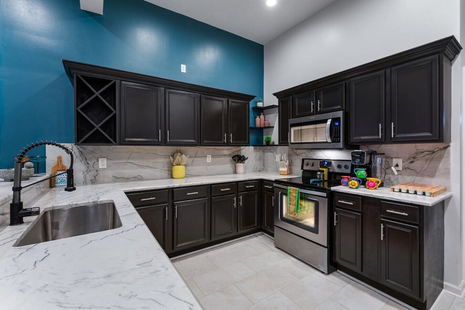 Stylish kitchen with sleek dark cabinets.