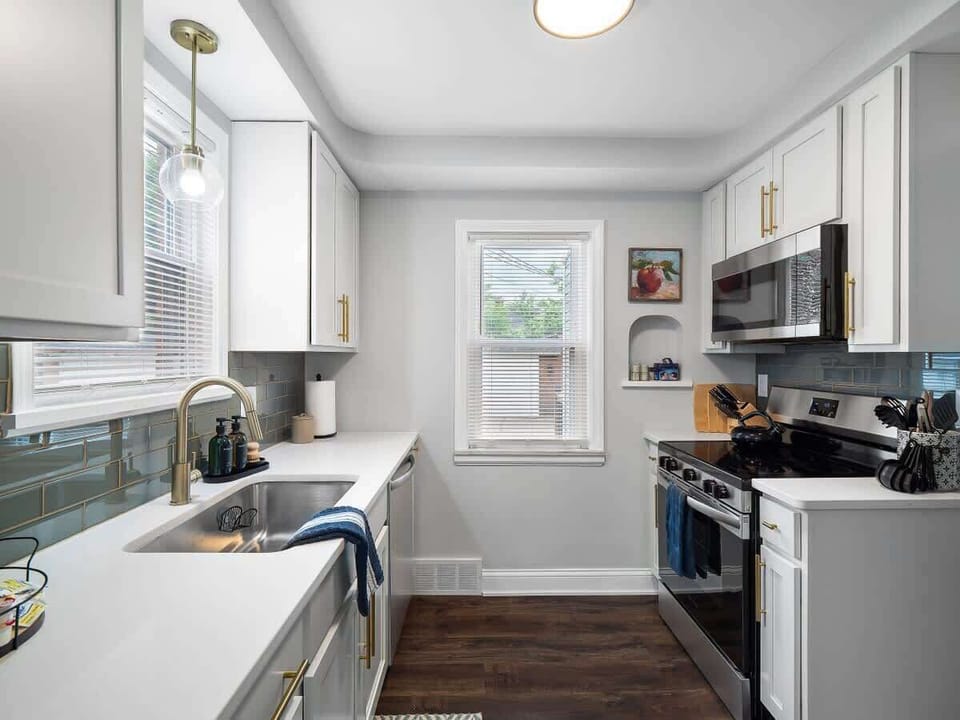 Well-equipped kitchen w/ stainless fridge, ample counters & bright natural light