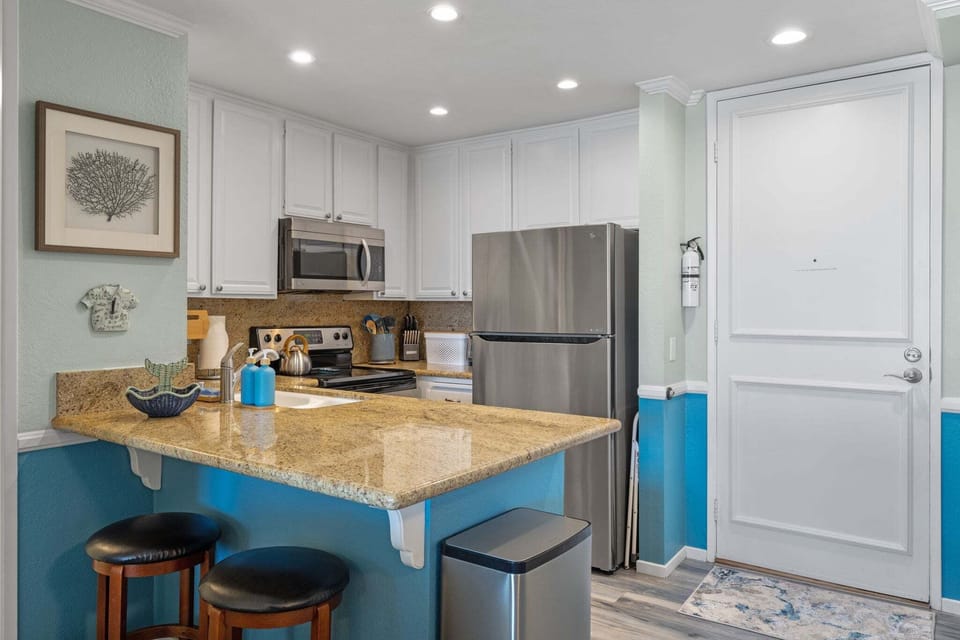 Two additional bar stools at the kitchen counter offer the perfect seating—especially for younger guests.