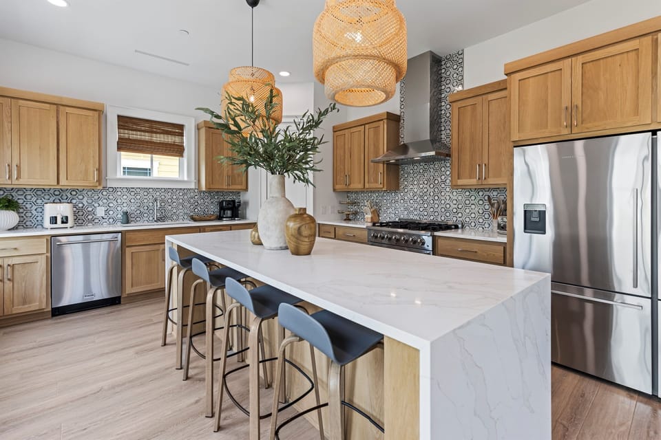Your spacious kitchen features marble counters, stainless appliances, and a breakfast island perfect for cooking and casual meals together.