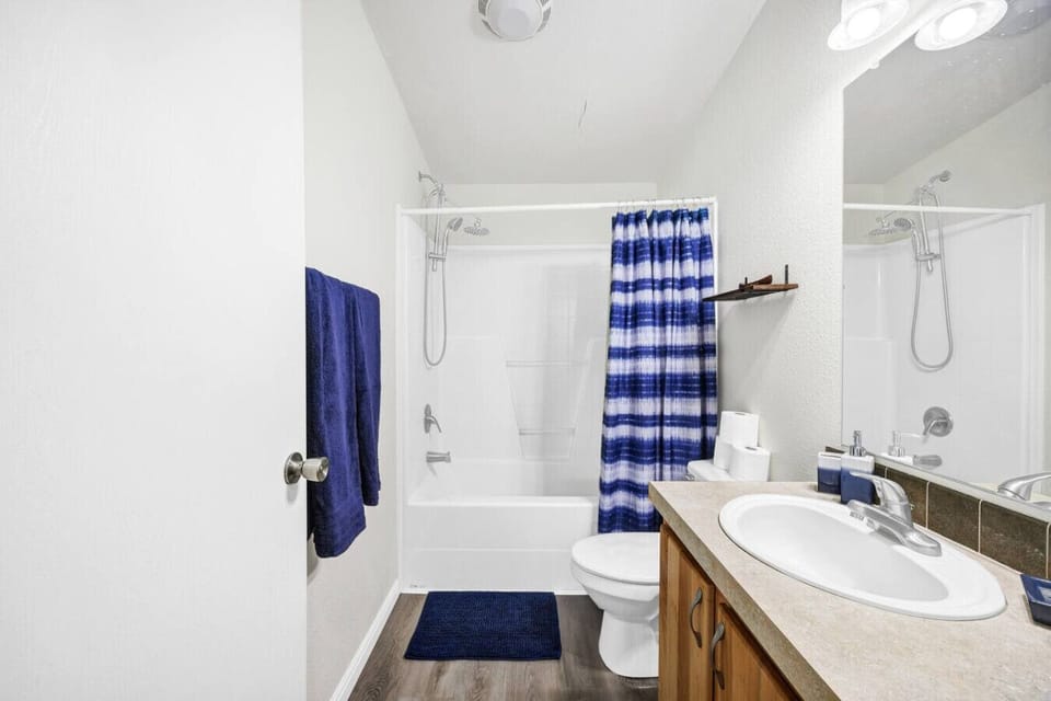 Full bathroom with a shower/tub combination, fresh towels, and guest essentials.