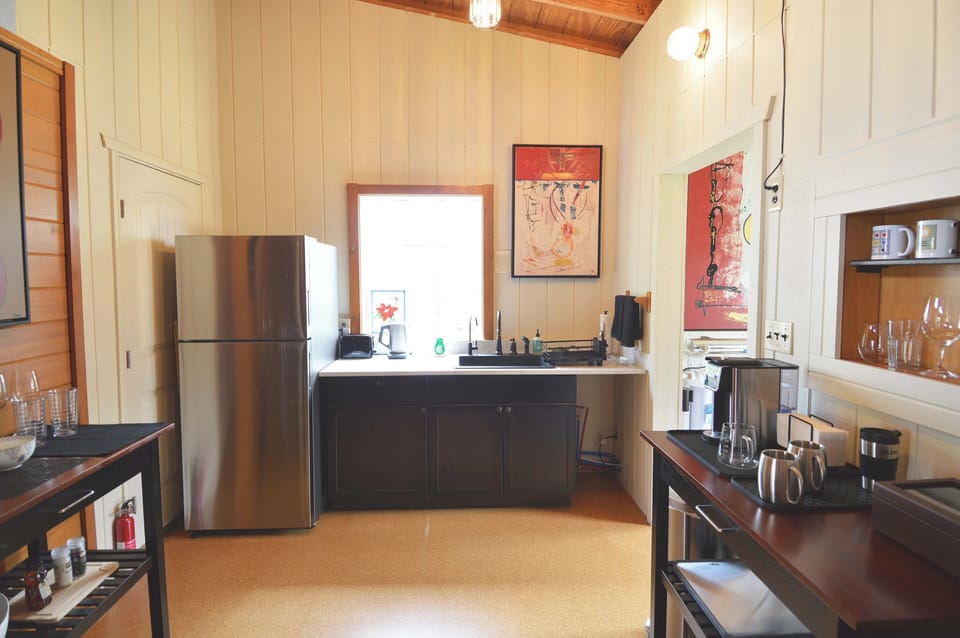 full sized frig, cabinets, sink, and various appliances and dishware