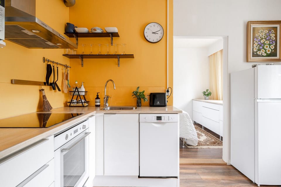 A cheerful, sun-filled kitchen fully equipped with modern appliances for all your culinary needs.