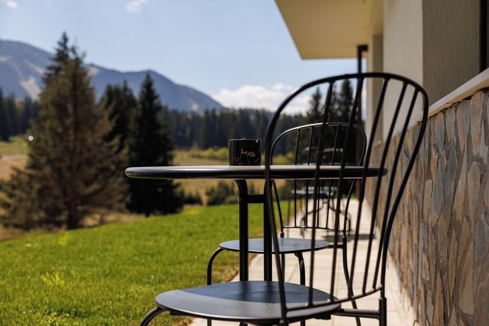 Breathtaking mountain views from the private terrace—sip your coffee or wine while watching the changing sky over the forested hills of Poiana Brașov.