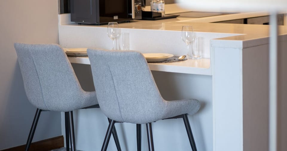 The kitchen and dining area layout and furnishings may vary slightly between rooms, yet each offers a stylish, comfortable, and well-appointed setting for your stay