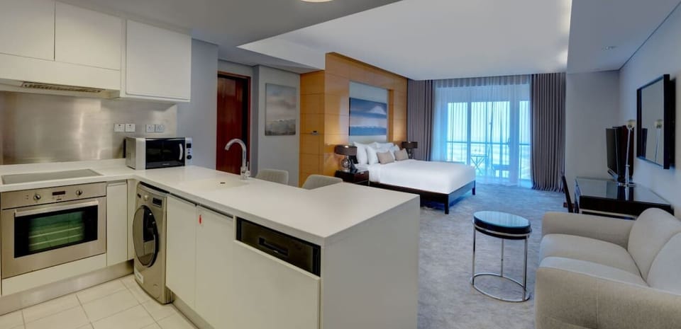 The kitchen and dining area layout and furnishings may vary slightly between rooms, yet each offers a stylish, comfortable, and well-appointed setting for your stay