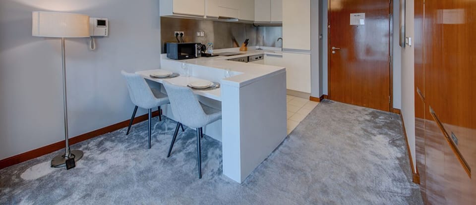 The kitchen and dining area layout and furnishings may vary slightly between rooms, yet each offers a stylish, comfortable, and well-appointed setting for your stay