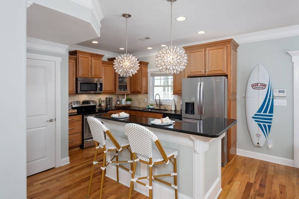 Bright and inviting kitchen with bar and 2 stools.