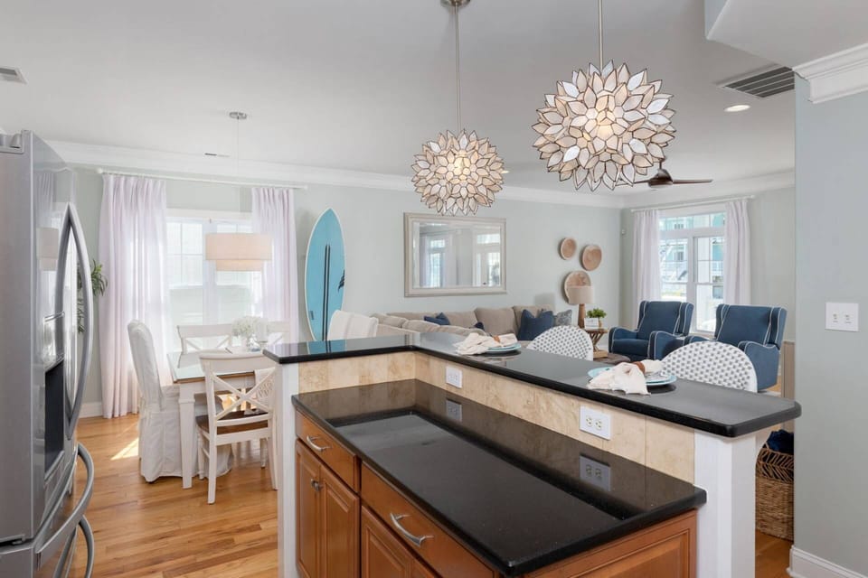Bright and inviting kitchen with bar and 2 stools.