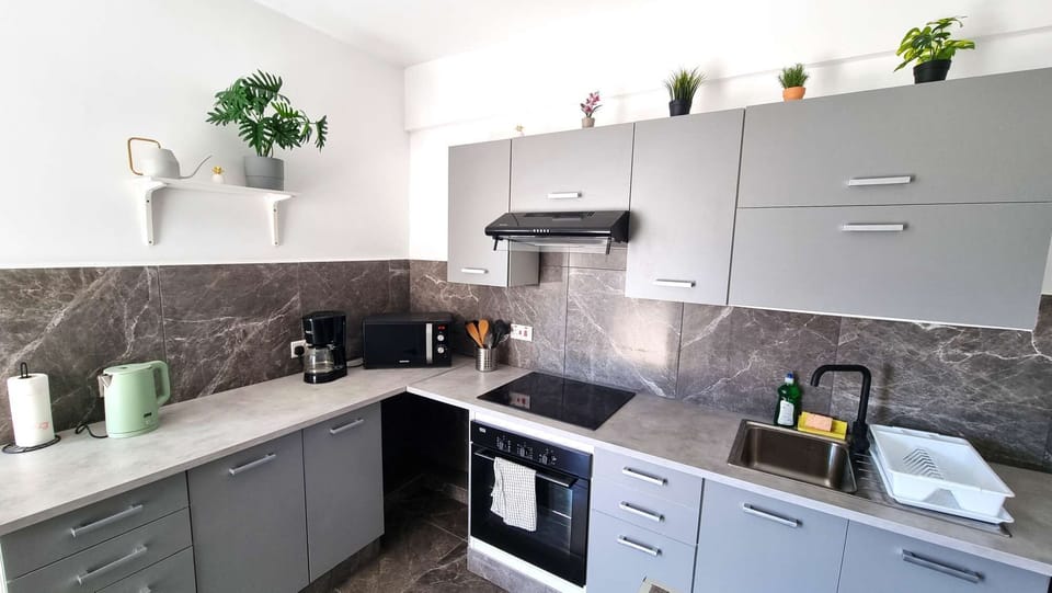 Kitchen, stove, cabinets, sink, kettle and microwave