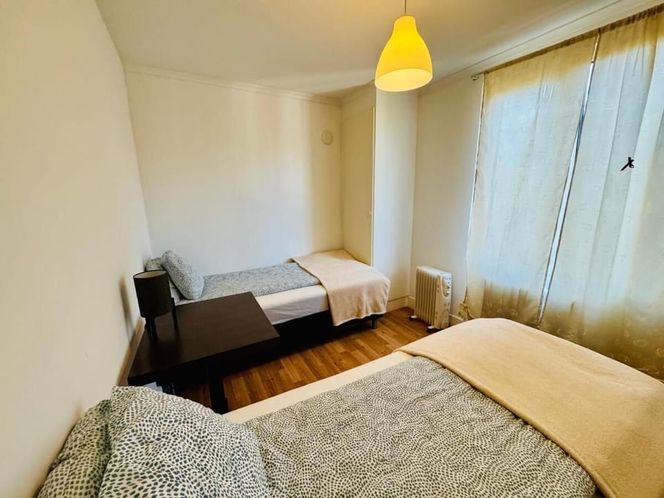 Desk, laptop workspace, bed sheets