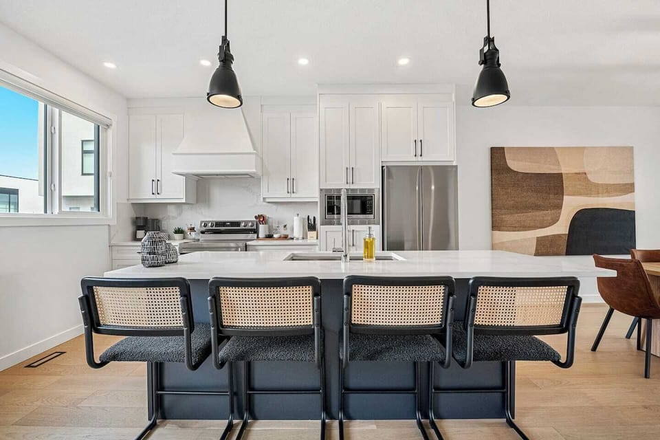 Kitchen with island seating, brand new appliances and open site lines to the dining and living area. 