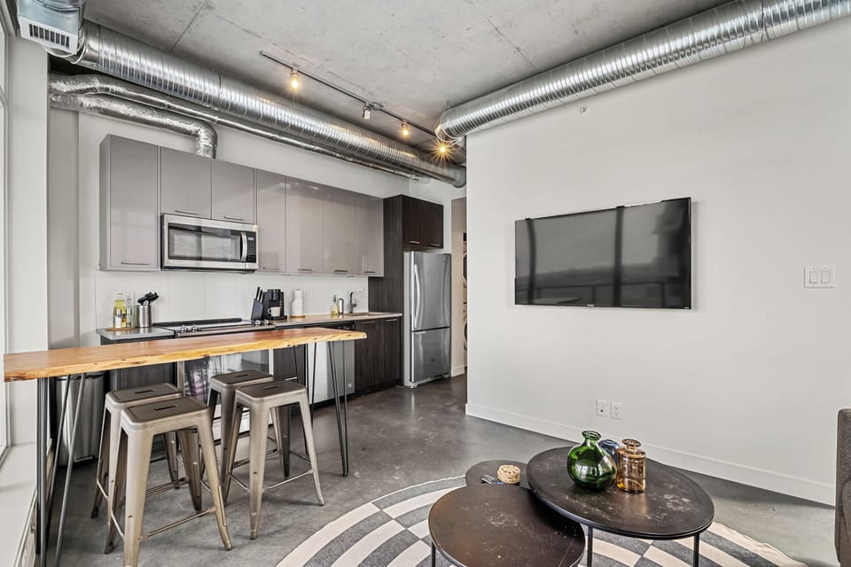 Enjoy a beautifully lit kitchen and dining nook with sleek appliances and an airy, modern feel.