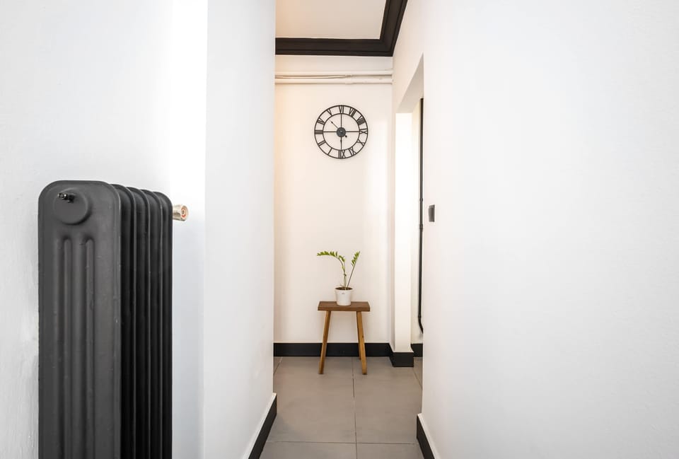 Clean interior hallway creating a calm transition between living and entry spaces.