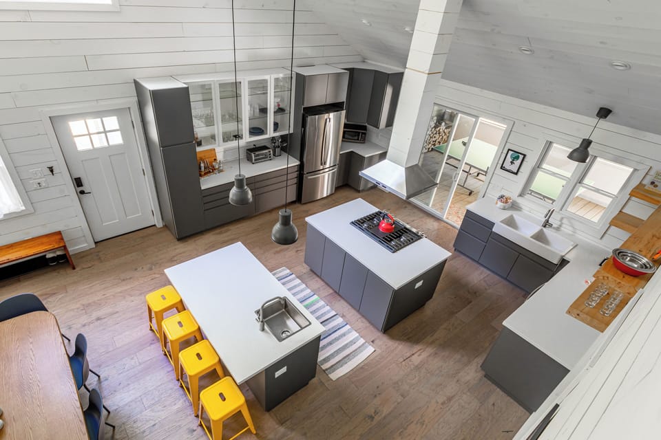 View from the loft area into the kitchen, showing the open flow of the home.
