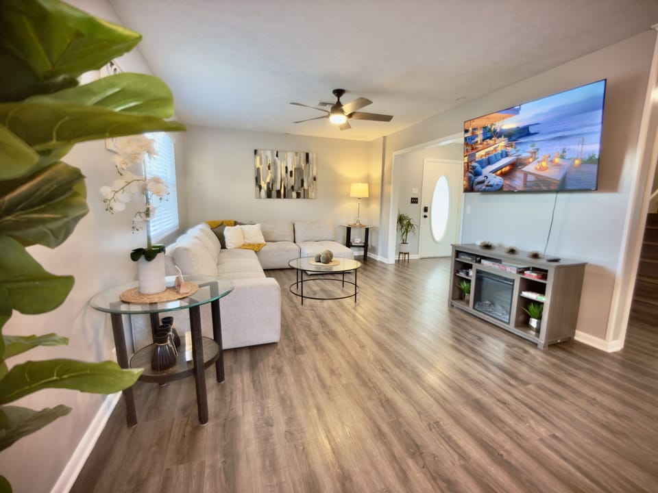 This thoughtfully designed living room offers a mix of modern elegance and homey comfort, providing a serene space to kick back and enjoy your stay.