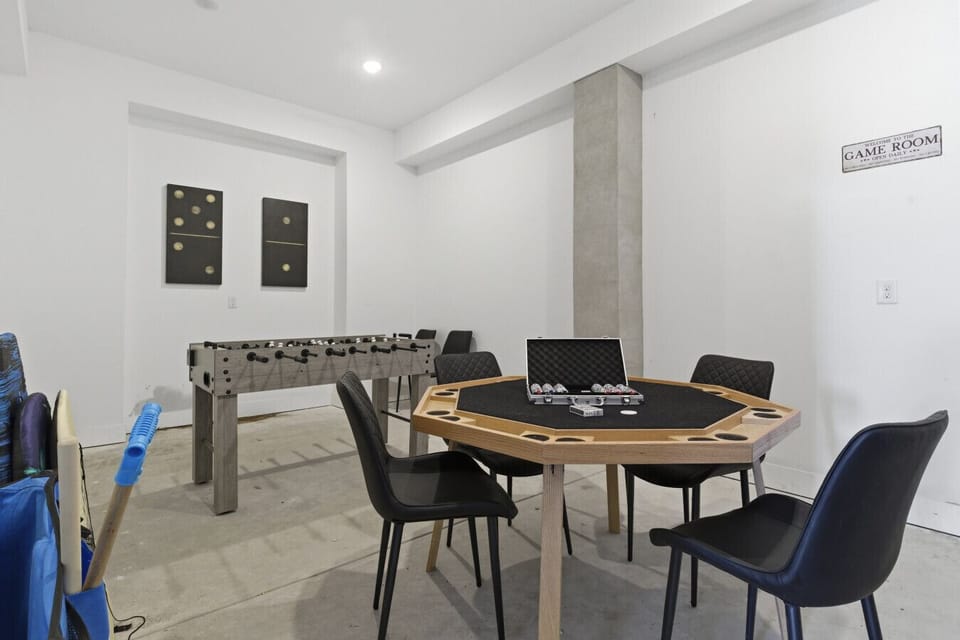 Entertainment space with poker table, foosball, and seating area