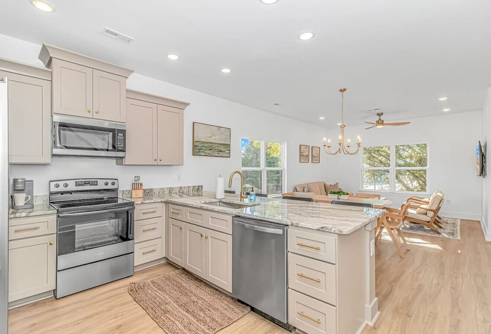 Spacious open floor plan with full kitchen, island seating, and living area