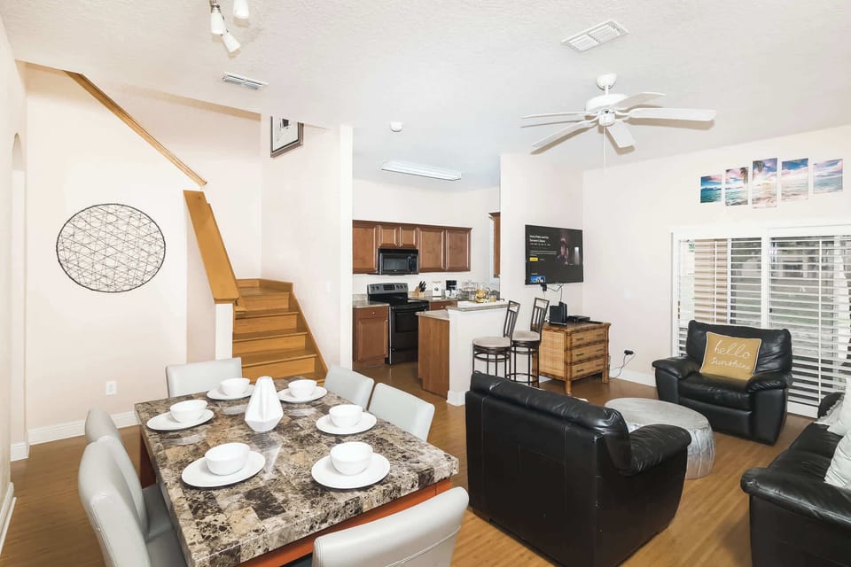 An open living space which features ample seating, cable TV, and access to the back patio