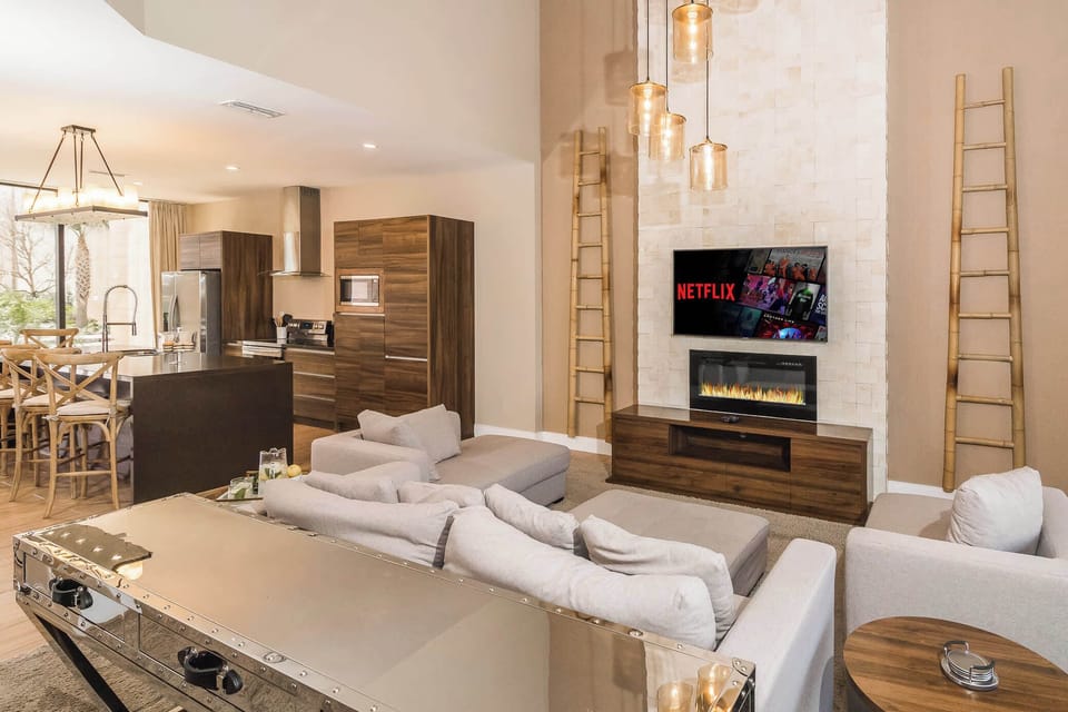 Open living space with Smart TV, fireplace, and patio access